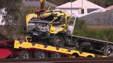 Deadly truck crash closes freeway and train line for hours