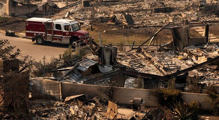 Los Angeles races to contain wildfires before severe winds return