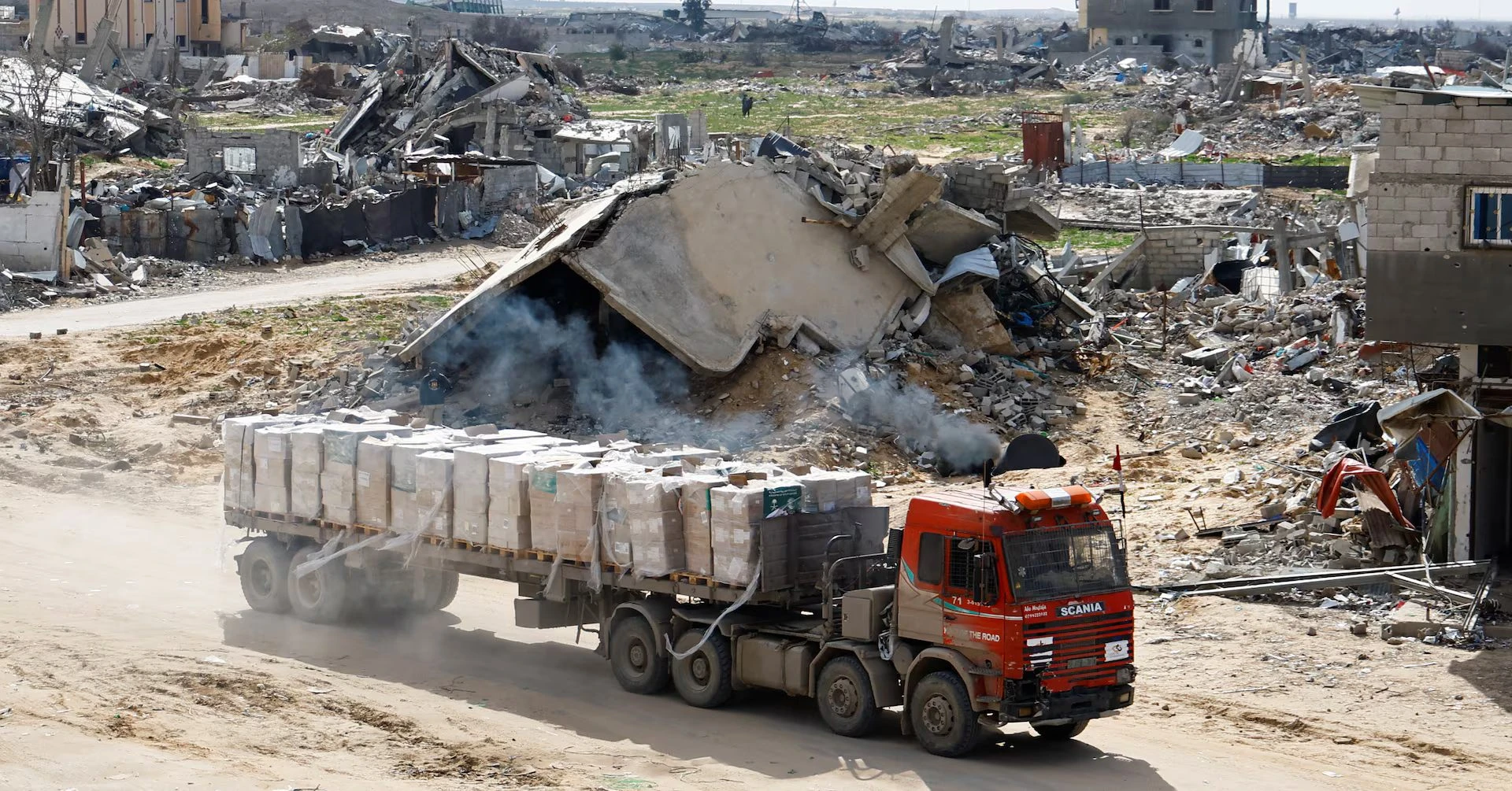 Three reported killed and dozens wounded near aid site in Gaza