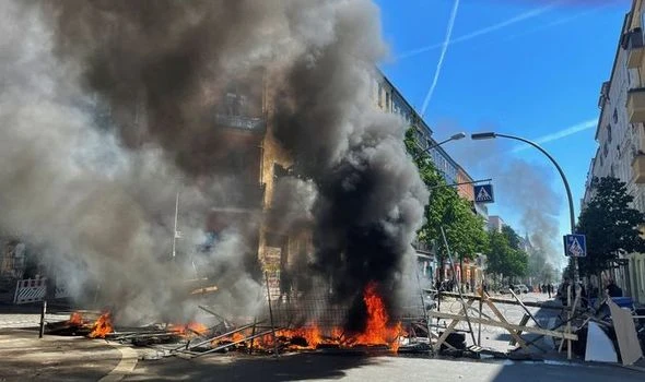 Berlin in flames: Left-wing radicals set barricades alight in fiery protest - police hurt