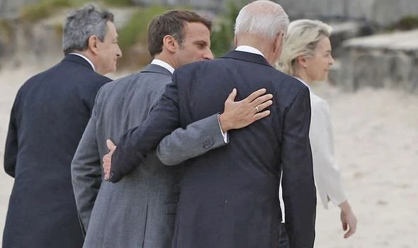 Moment Macron swoops in on Biden for a Covid-breaching whisper seconds after G7 photo