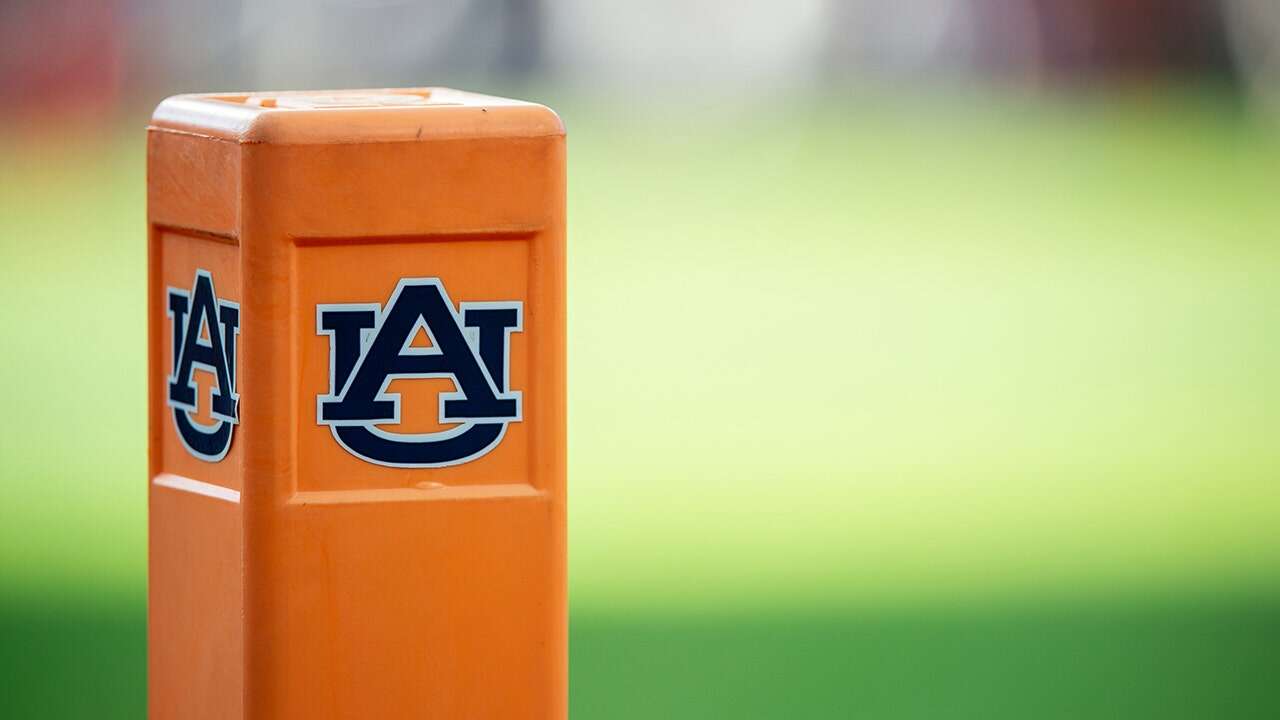 Auburn cheeleader knocks down Oklahoma player running onto field while performing stunts