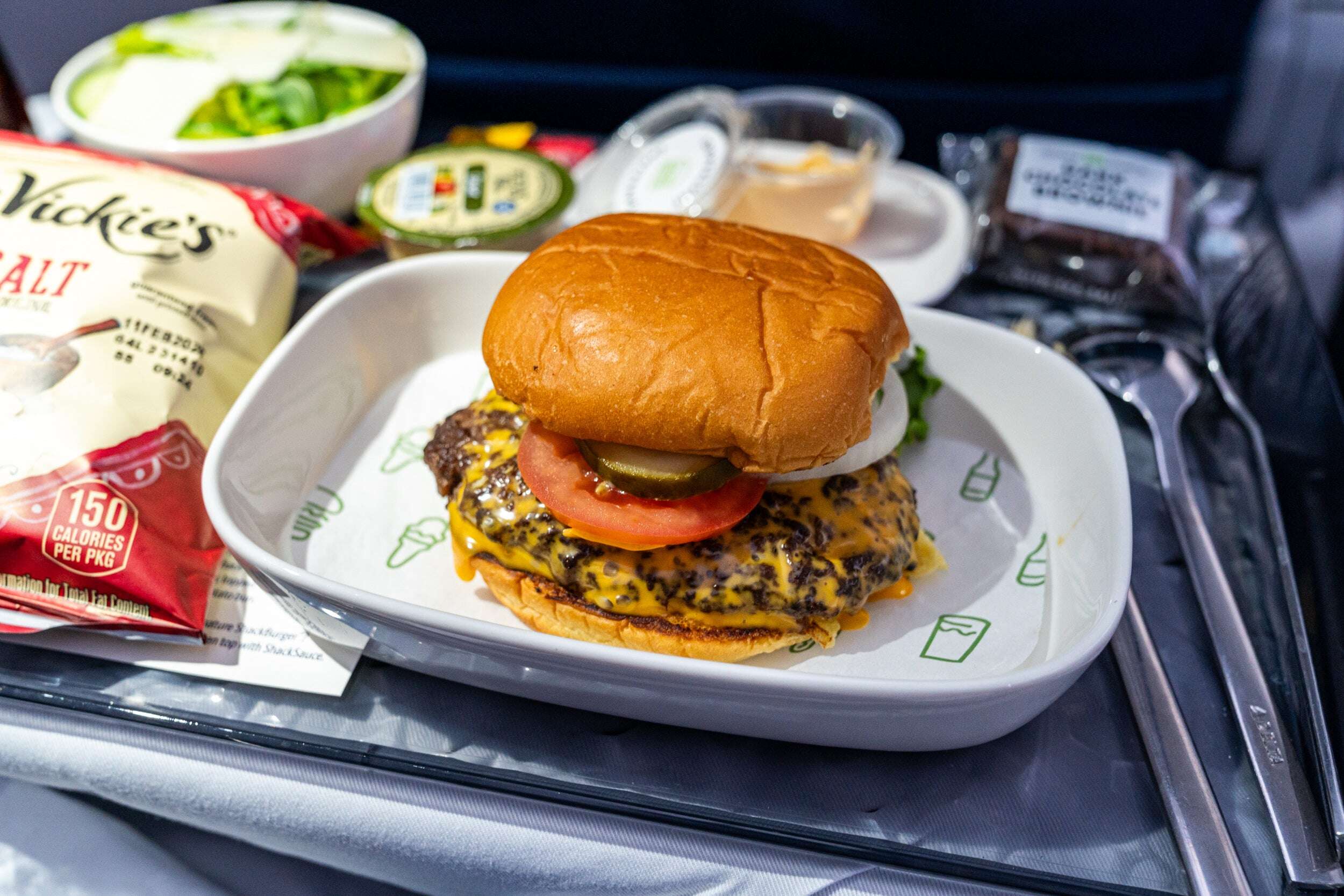 Delta expands Shack Shack burgers to more flights, adds fancy Champagne — and trials Red Bull