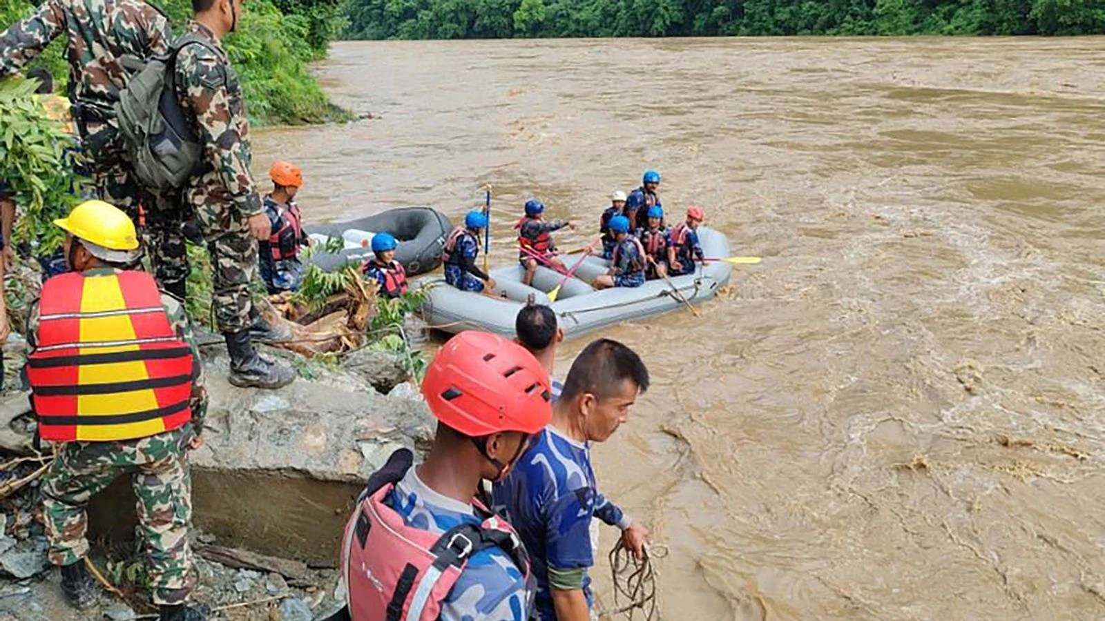 Bodies found after buses swept into river by landslide, officials say