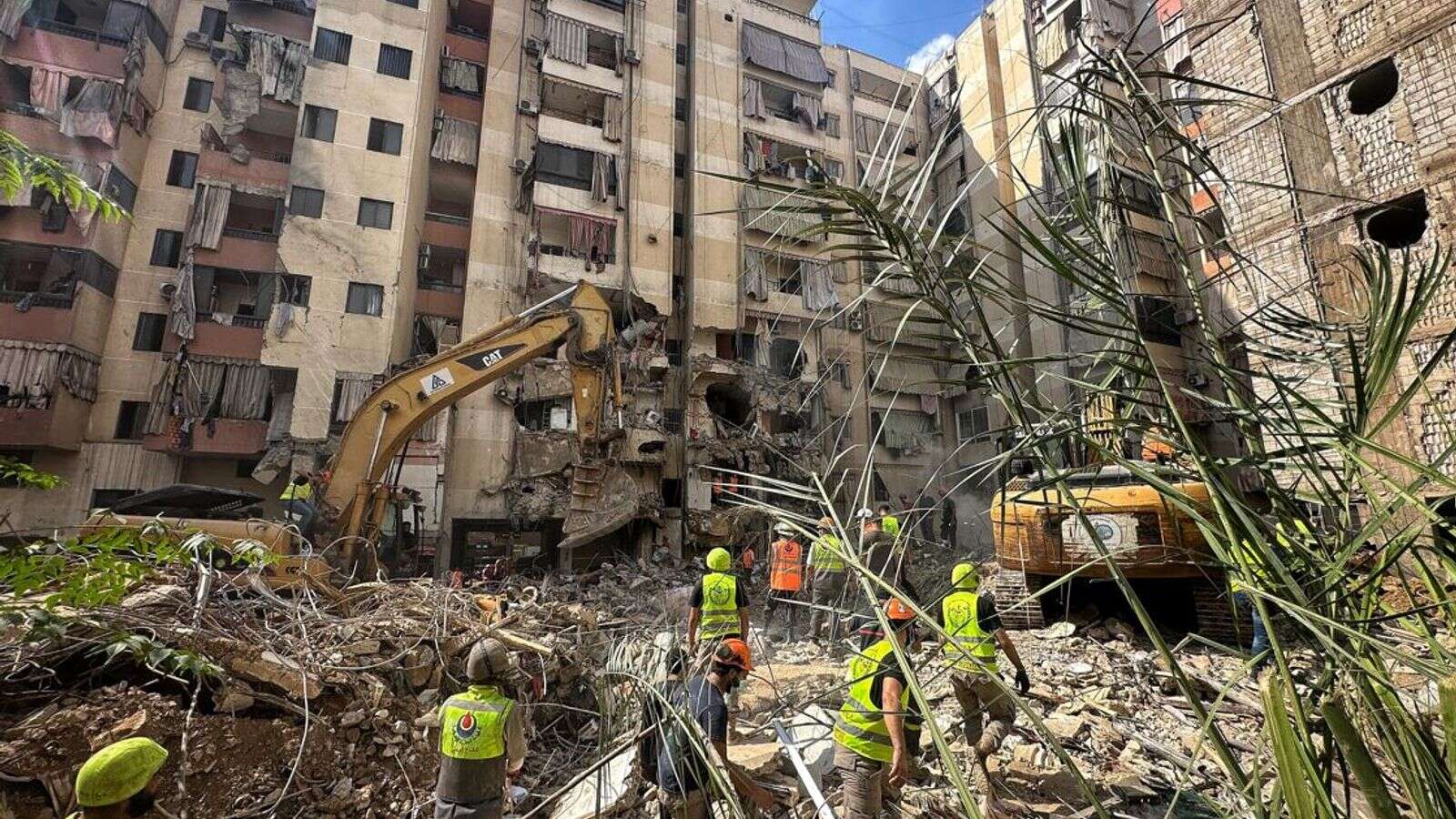 Anxious families line the pavement as dozens remain missing in the rubble after Beirut strike