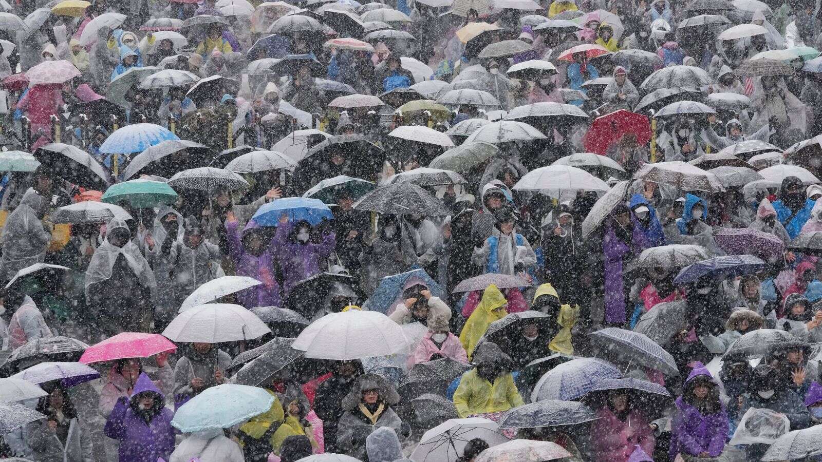 Thousands brave freezing conditions to protest South Korean president as he faces arrest