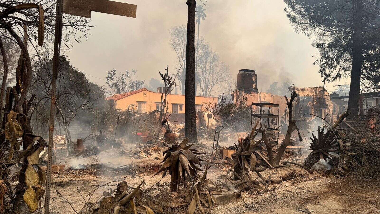 Truly apocalyptic: Flames swallowing homes and cars and lives wrapped up in a blanket of belongings