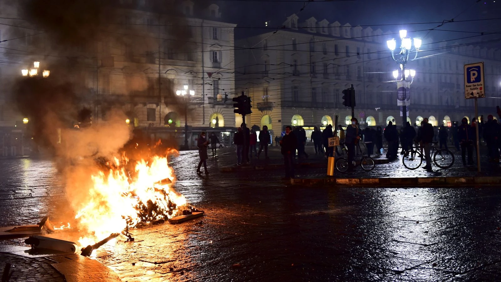 Lockdown protesters in Italy throw bottles and smoke bombs as stricter rules come in