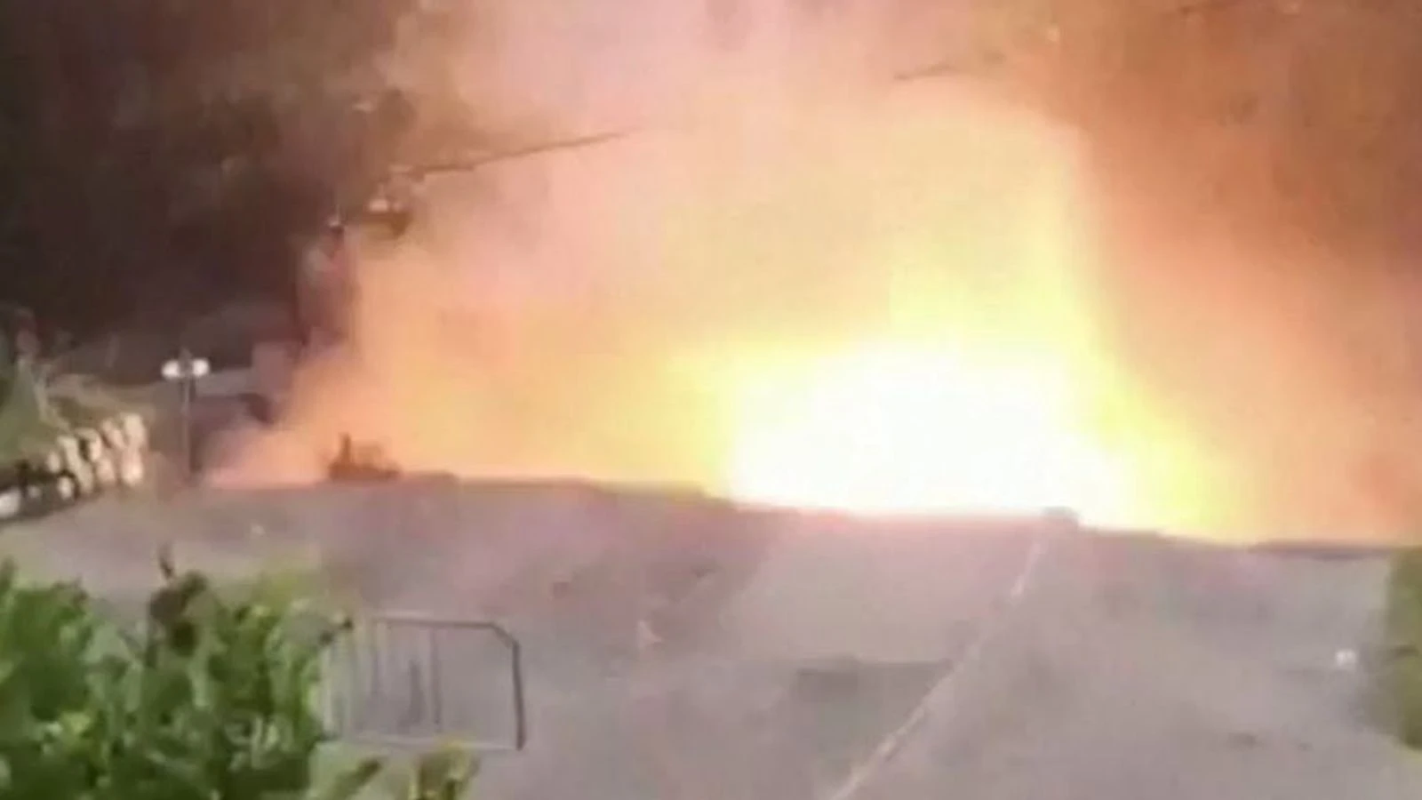 Fiery blast as flood causes road to collapse