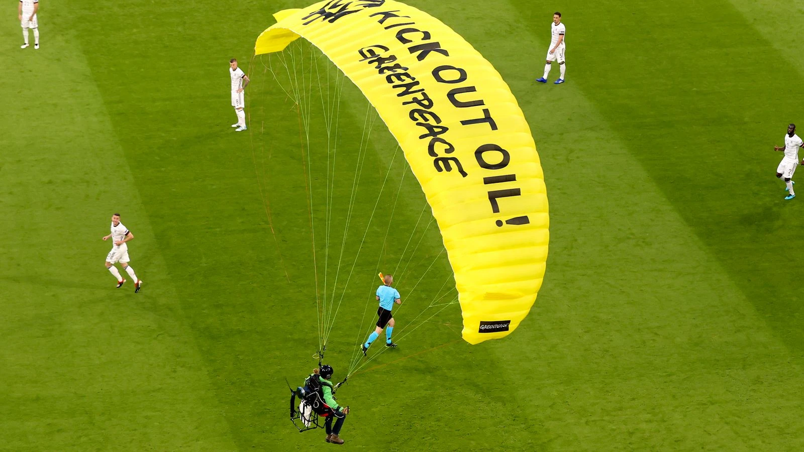 Climate protester parachutes on to pitch at Euro 2020 game