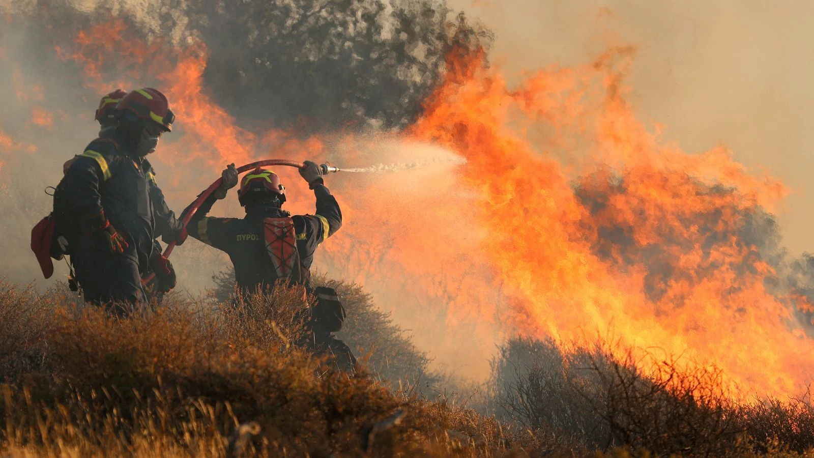 Wildfire tears through part of Greek island - forcing hundreds to flee homes and hotels