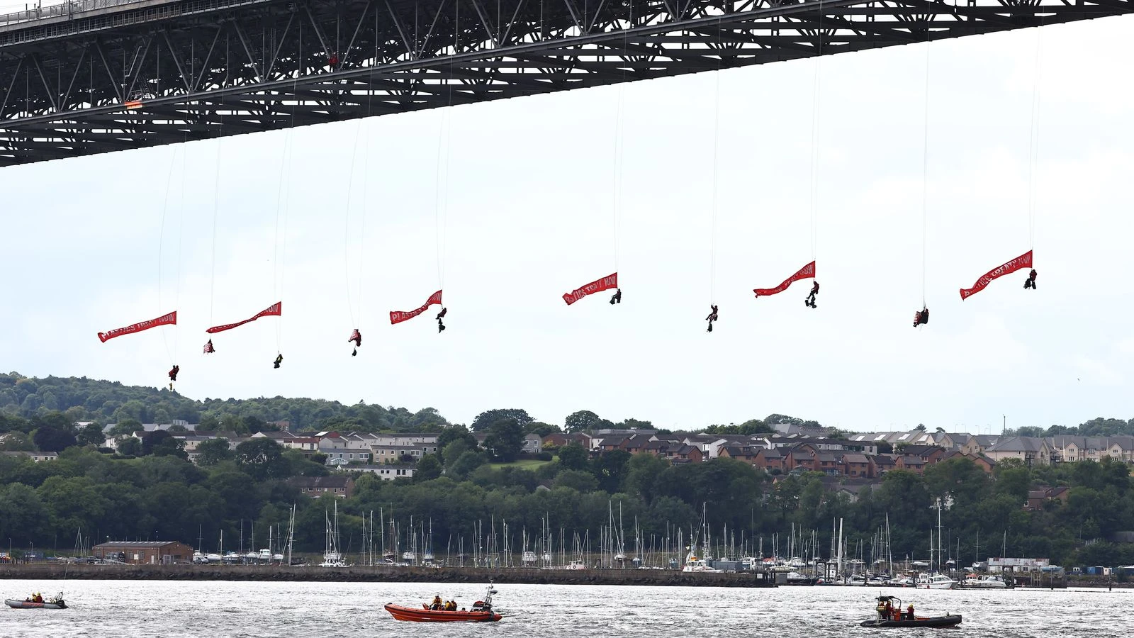 Ten Greenpeace activists arrested after suspending themselves from bridge