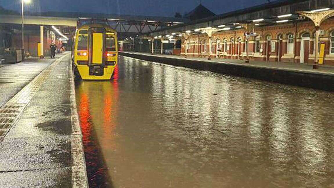 Heavy rain brings travel disruption with cars stranded and trains suspended