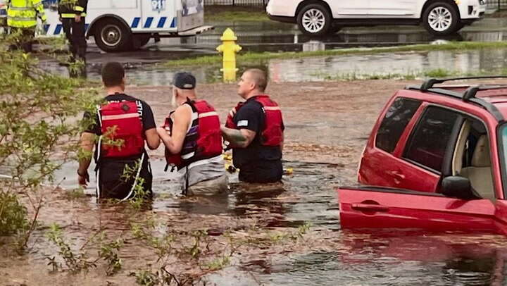 Watch: Florida driver ‘slowly sinking in mud’ rescued by firefighters