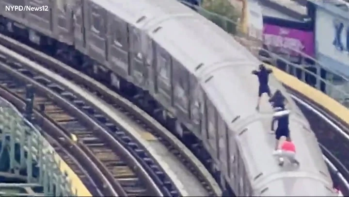 Subway surfers caught travelling on top of moving train by drone team