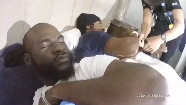 Moment police handcuff bleary-eyed drug dealers sleeping in bed