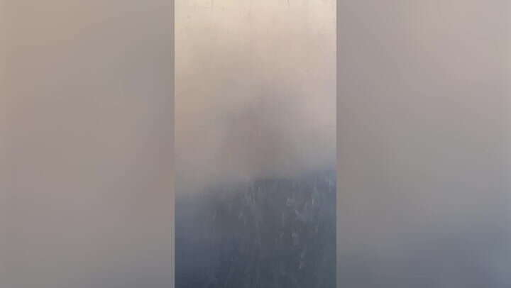 Passenger films plane battling wildfire smoke in turbulent LA landing