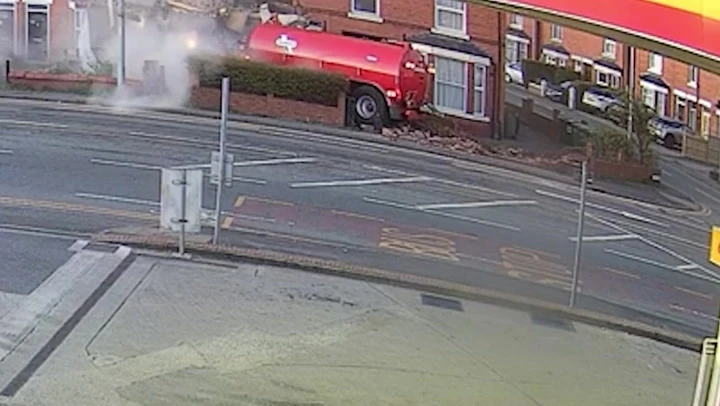 Moment tractor smashes into homes after drug driver runs red light