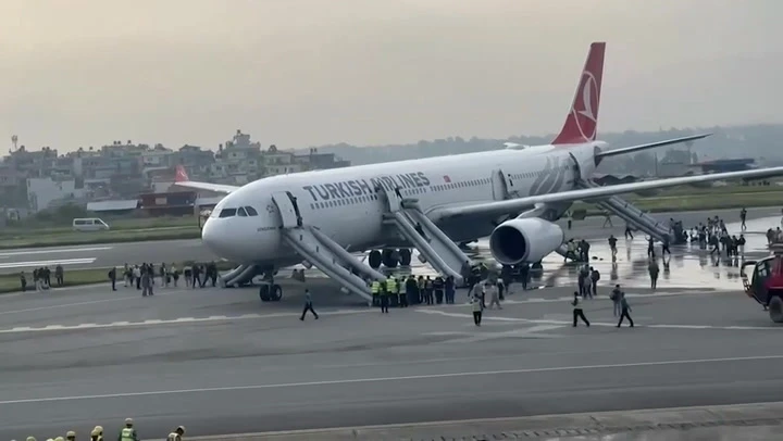 Plane passengers evacuate after aircraft catches fire on landing