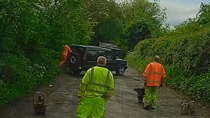 Land Rover driver ignoring closed road knocks over pothole worker