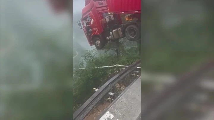Lorry driver left dangling over edge of 700ft collapsed bridge