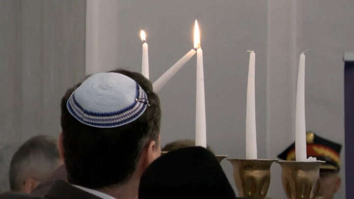 Polish parliament lights Hanukkah candles extinguished by politician