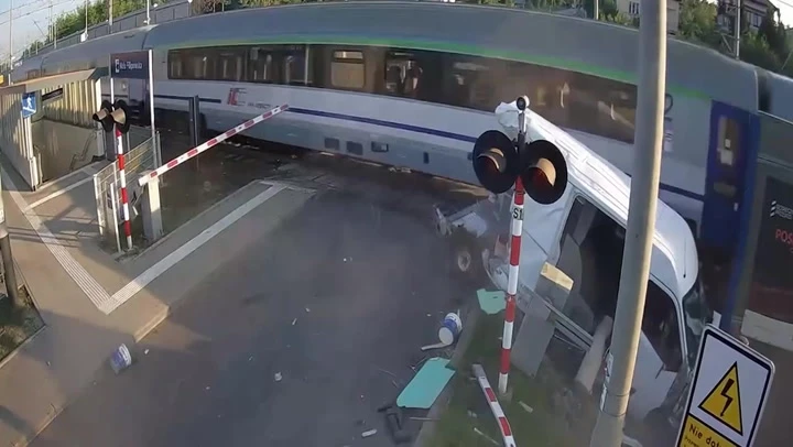 Train slams into van at level crossing after driver runs red light