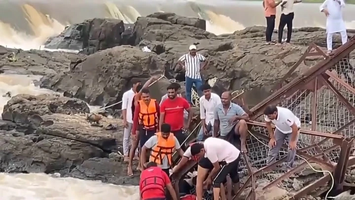 Watch: Rescuers on scene as bridge collapses into river in India