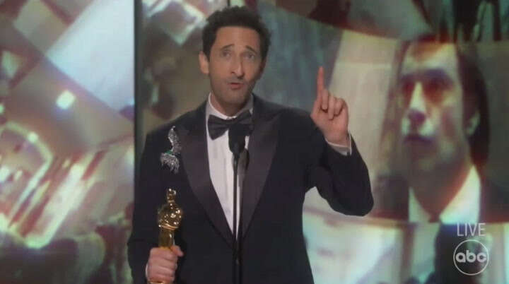 Adrien Brody tosses gum then shushes walk-off music during Oscar win