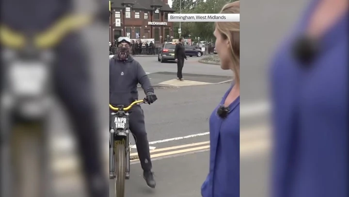 Protesters surround reporter in Birmingham slashing tyre of TV van