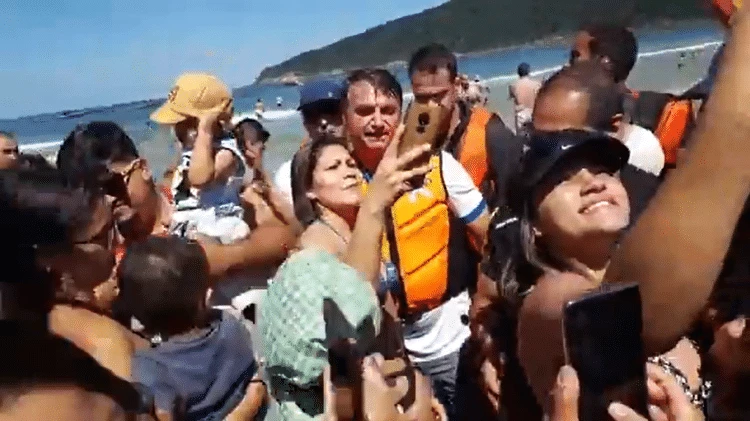 Bolsonaro gera aglomeração e tira selfies com banhistas em praia de SP