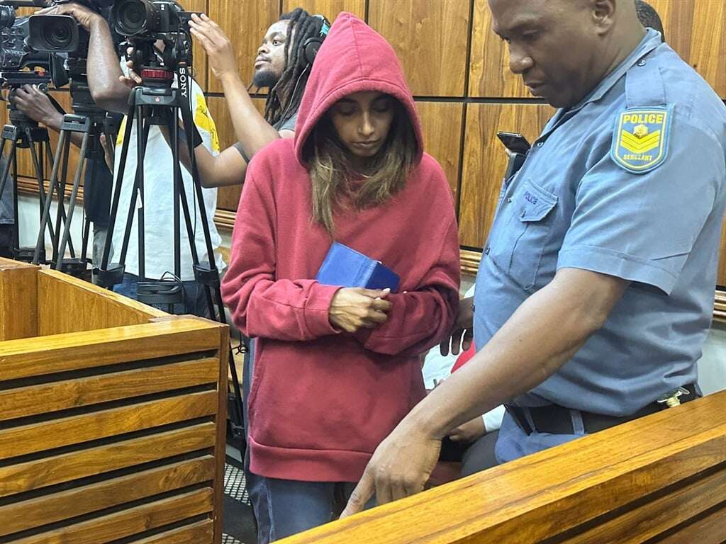 Clutching Bible in hand, girlfriend of alleged child pornography kingpin appears in court