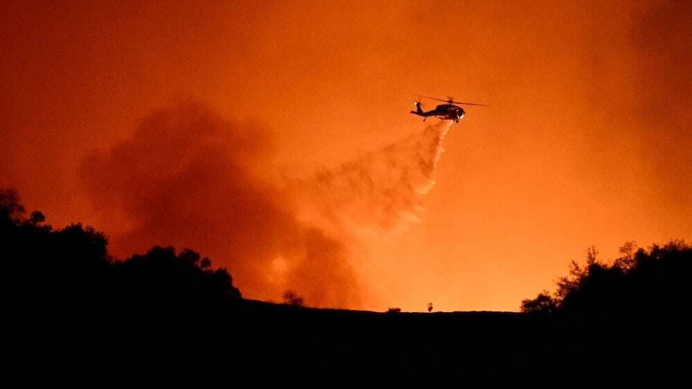 Los Angeles investigates cause of fires as curfew enforced