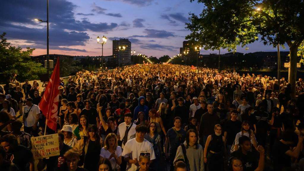 France's far-right National Rally projected to win snap election but without absolute majority