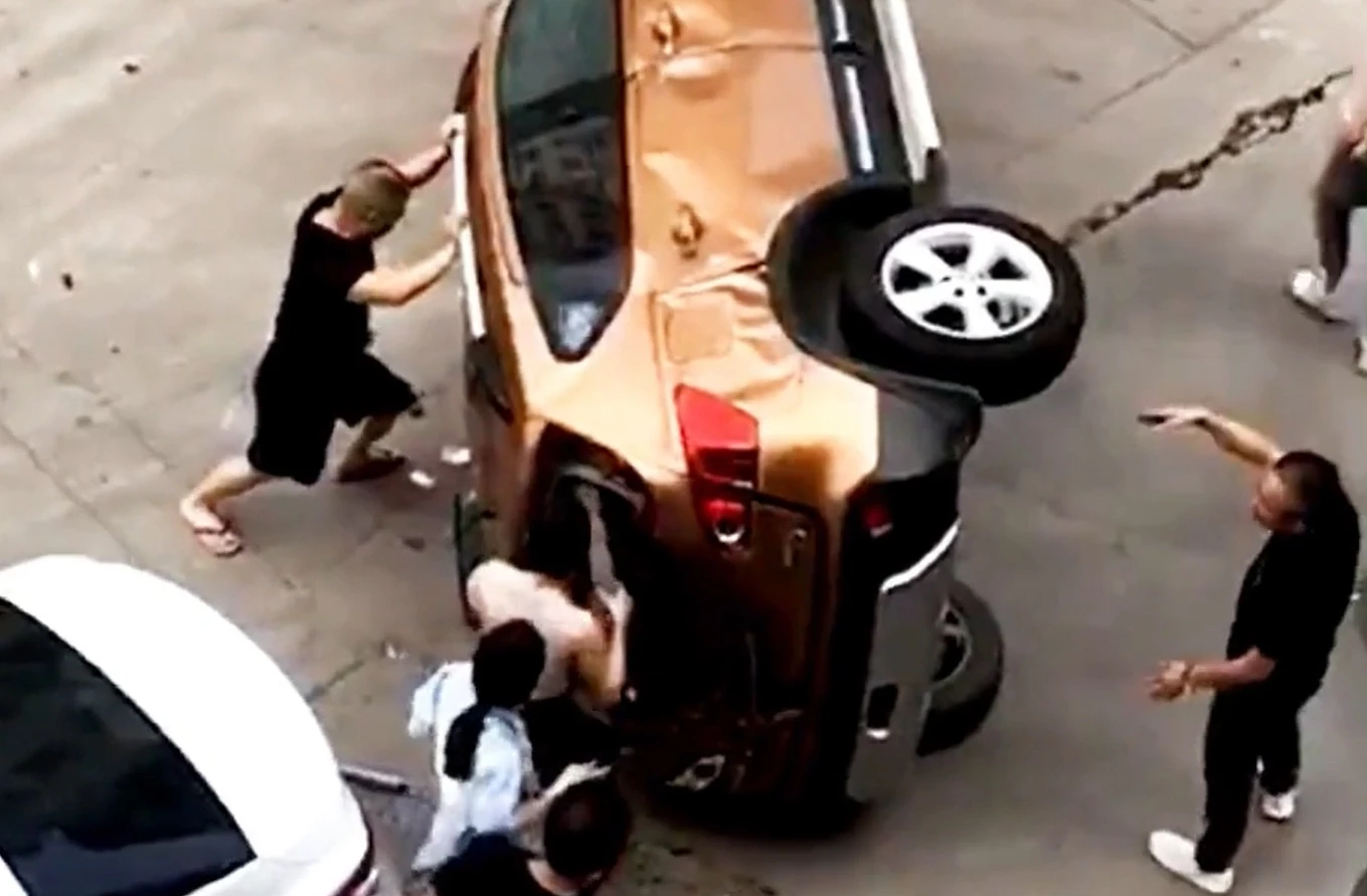Crowd rescue mother and son trapped in car after crash