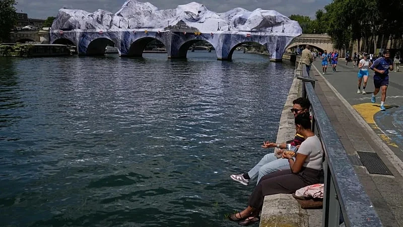 Crowds flock to JR's giant cave installation on Paris' Pont Neuf