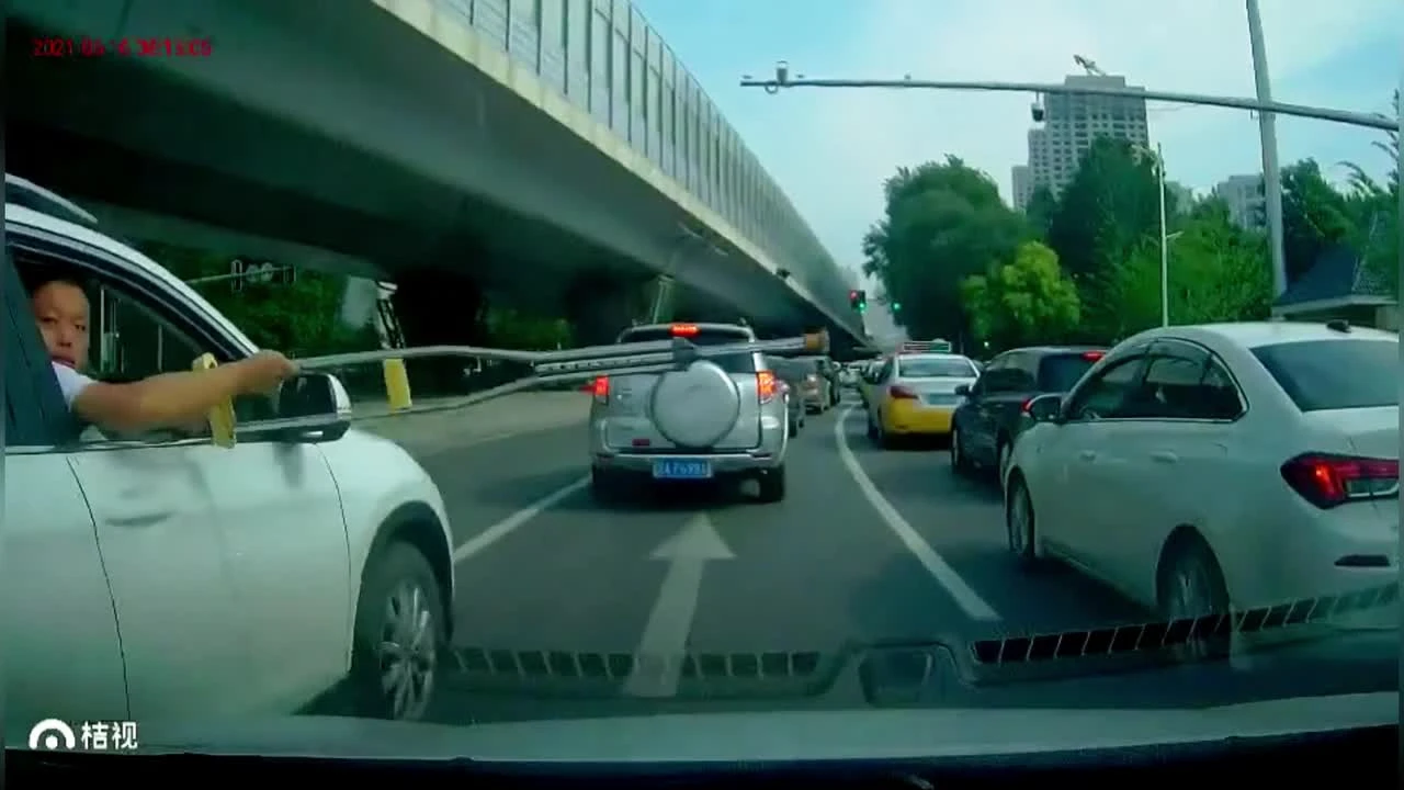 Passenger dangles crutch out of car window