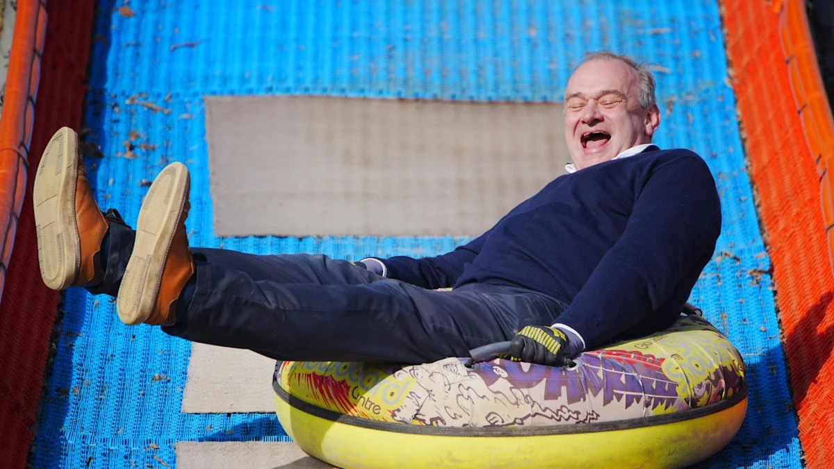 Sir Ed Davey rides rubber ring to highlight pothole problem