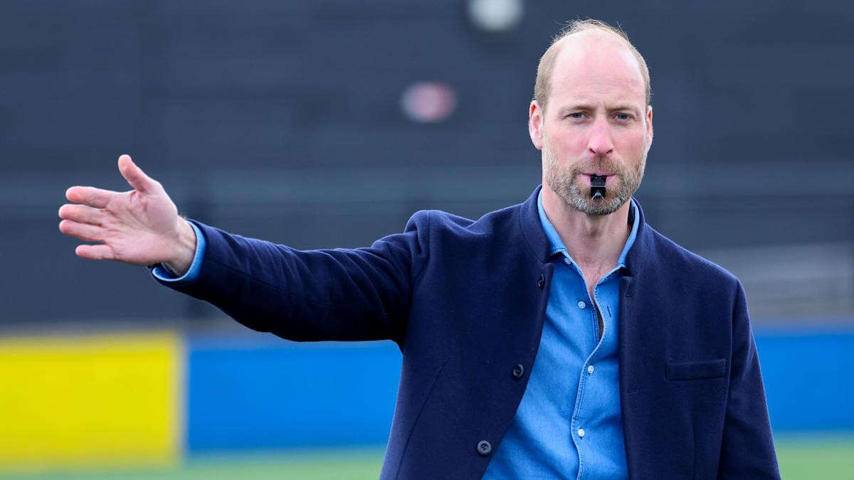 William poses for selfies with schoolchildren and referees football match