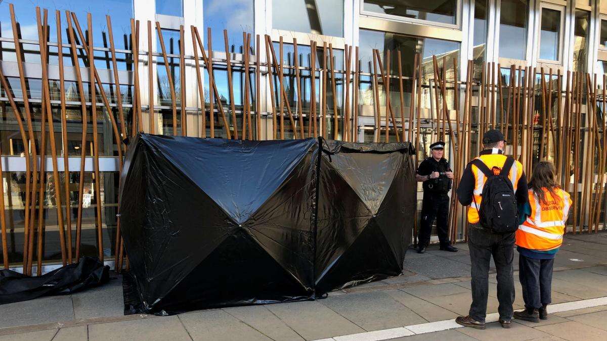 Climate activists clamp themselves to Scottish Parliament building