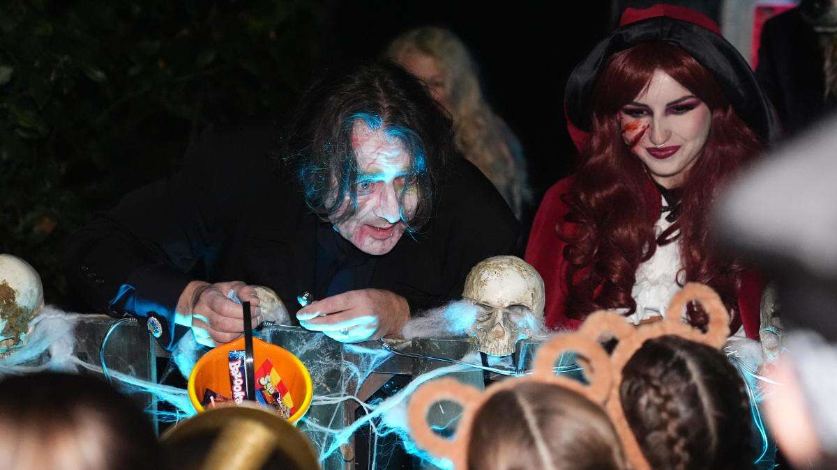 Jonathan Ross delights trick-or-treaters with sweets outside his London home