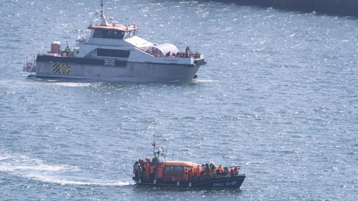 Migrants brought ashore in lifeboat after crossing English Channel