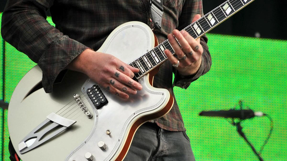 Queens Of The Stone Age headline festival rocked by controversy