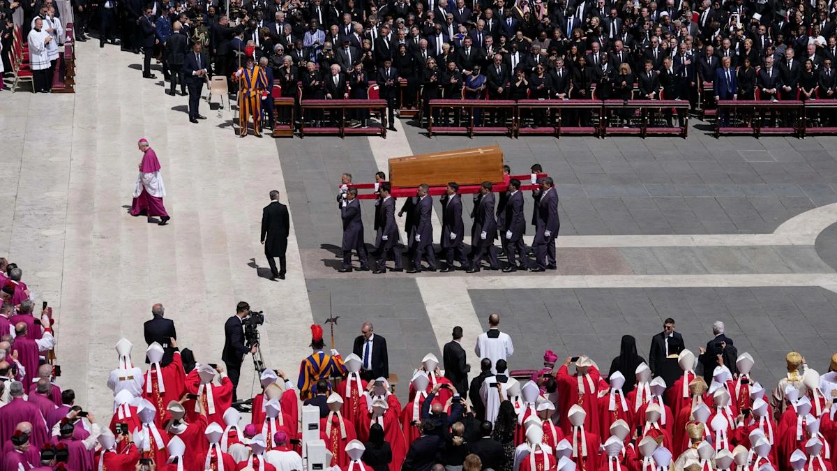 Quiet reverence and a ripple of applause for ‘the people’s pope’