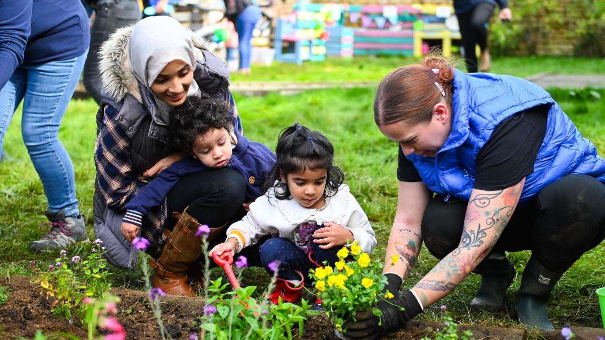 Lottery winners help spruce up garden for toddlers at charity farm