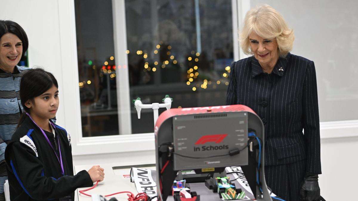 Camilla wins mini F1 race during visit to new school in east London