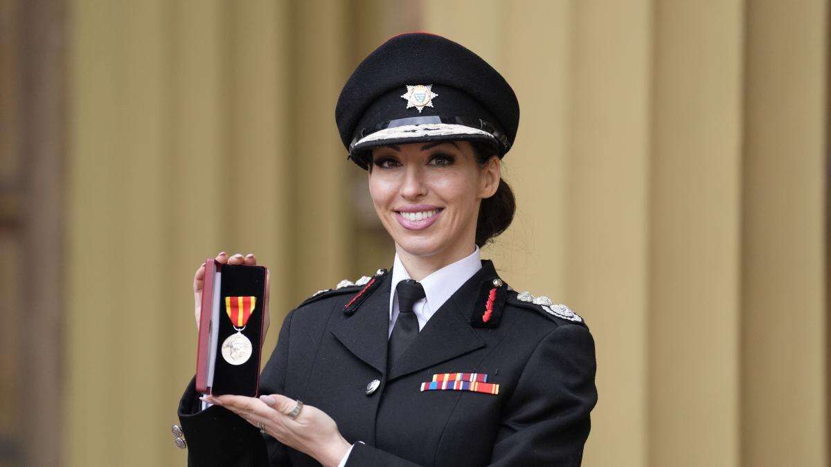 Firefighter who battled poverty and homelessness as a teenager honoured by King