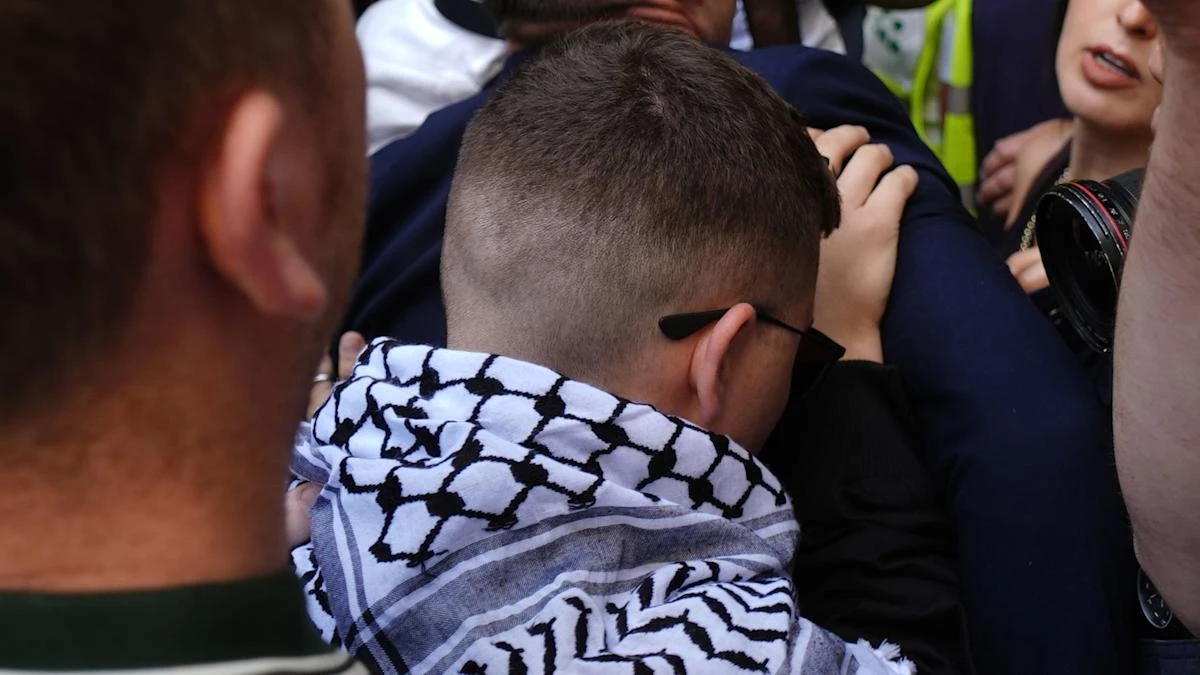 Kneecap greeted by hundreds at court as rap group member faces terrorism charge