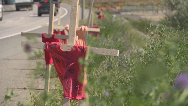 Small red dresses line B.C. highway in tribute to children found in burial site