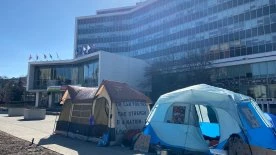 Tents pitched at Hamilton city hall prior to vote choosing parking lots over housing